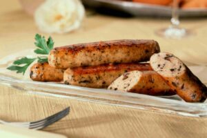 Chicken sausages on plate with herbs