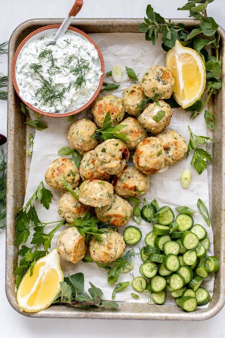 Easy minty chicken meatballs platter party food served with yoghurt sauce and fresh lemon slices