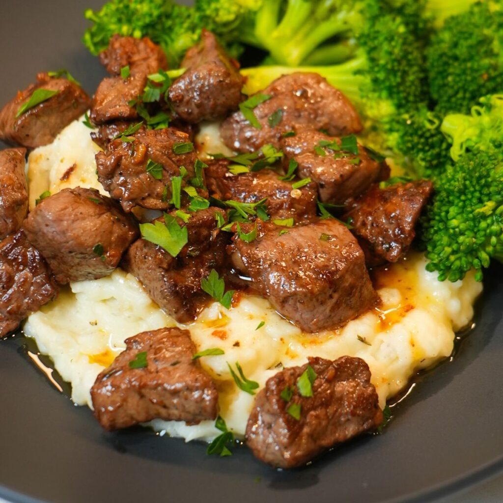 Garlic butter Beef bites on mash potatoes 