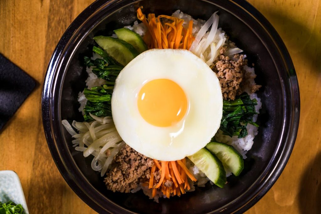 Korean Rice Bowl made with ground beef, fresh vegetables and fried egg