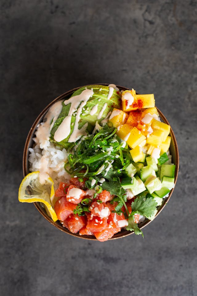Korean Rice Bowl with Salmon, Avo, cucumber. Healthy meal for summer