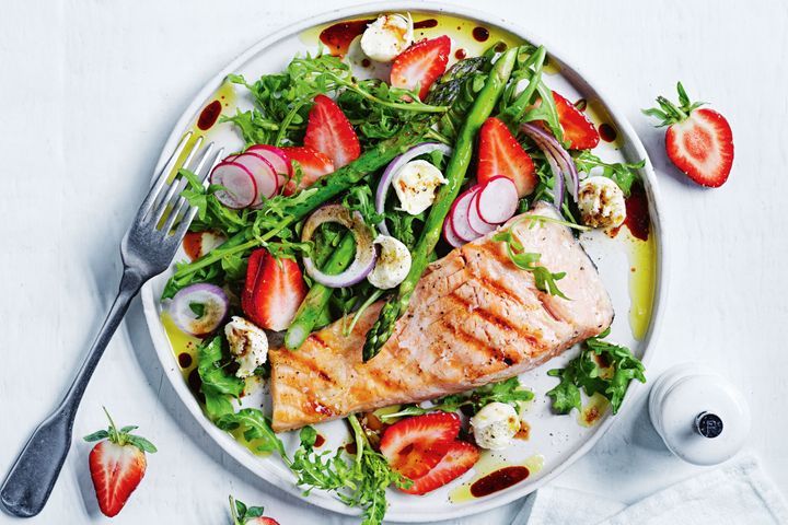 Healthy pan fried lemon and herb salmon with Greek salad 